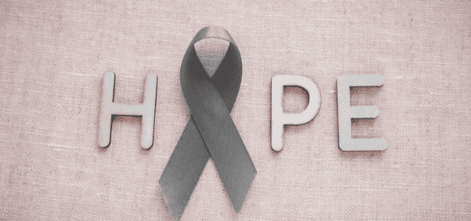 The word 'HOPE' spelled out with a gray awareness ribbon replacing the 'O,' set against a light pink textured background.