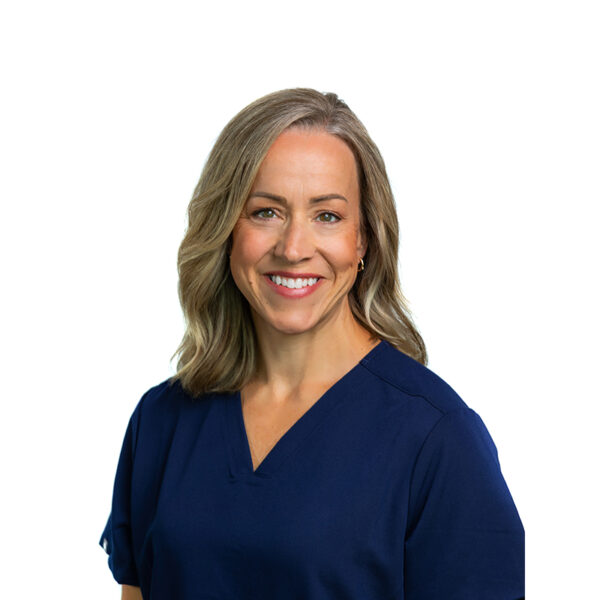 A woman with medium-length brown hair, wearing a purple top and smiling, standing in front of a white background.